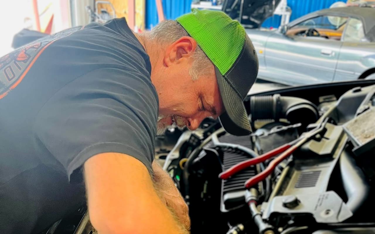 Lee working under the hood at Impact Auto Repair